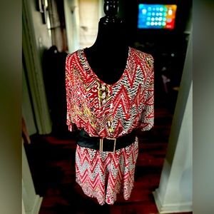 A red earth tone color short jumpsuit